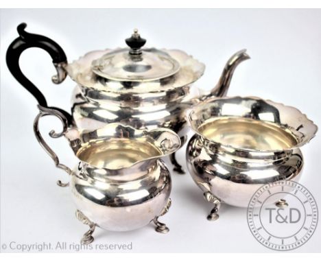 An Edwardian silver three piece tea service, J Sherwood & Sons Birmingham 1906, each piece of compressed ovoid form with rais