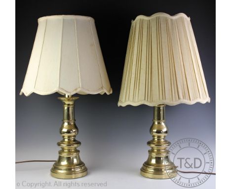 A pair of Dutch style brass lamp bases, each of baluster form on circular bases, with shades, 74cm high CONDITION REPORT: Lig