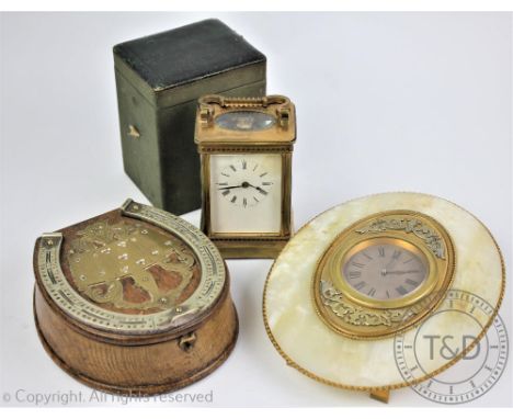 A 19th century lacquered brass French timepiece, white dial with black Roman numerals, bevelled glass and visible escapement,