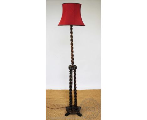 A 1920's oak standard lamp, with barley twist clustre column, on circular base, 151cm H CONDITION REPORT: Lighting lots are s