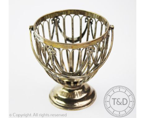 An Edwardian silver sugar basket, Haseler Brothers, Chester 1904, of cup shape with galleried bow and garland frame, 15.5cm h