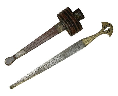 Sudanese arm dagger with 40cm steel double edged blade and decorative pierced brass hilt; in tooled leather scabbard with arm