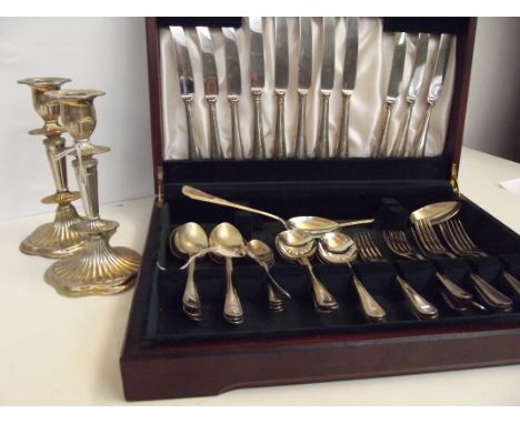 Cased Elkington canteen of cutlery in silver plate (one item deficient) together with a pair of silver plated candlesticks 