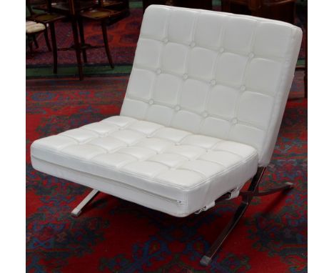 A designer chrome and leather effect Barcelona easy chair, button upholstered Pellissima covered back and seat.