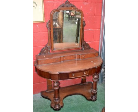 A Victorian Duchess dressing table, architectural pediment, carved uprights, three drawers to superstructure, demi-lune top, 