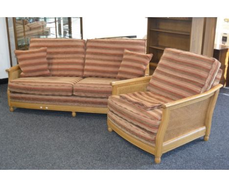 An Ercol Bergere range 16032FLT  light oak two seat sofa with canework ends; a conforming armchair. (2)