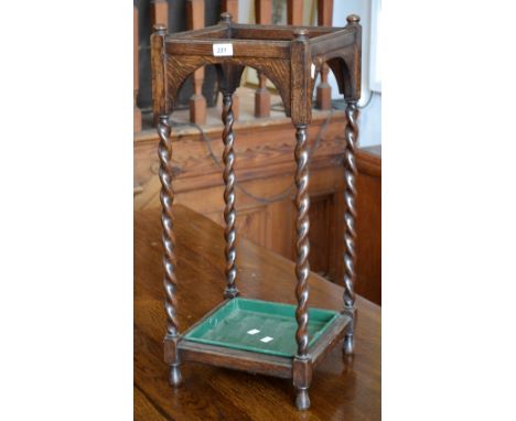 An oak square stick stand, barley twist legs, with tray by John Taylor and Son, Edinburgh 