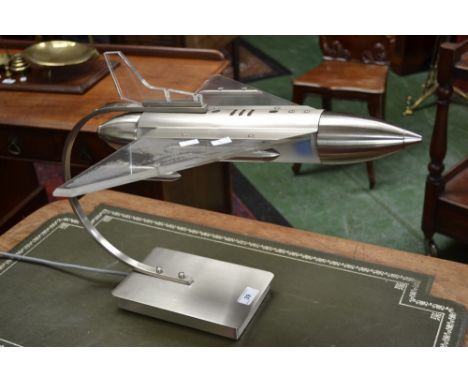 A novelty table lamp in the form of a brushed steel and perspex Delta wing fighter plane.