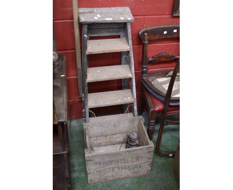 A vintage step ladder; a pitch fork; a Feuer Hand 275 Baby storm lantern; a vintage crate - Tarantella peeled tomatoes. (4)