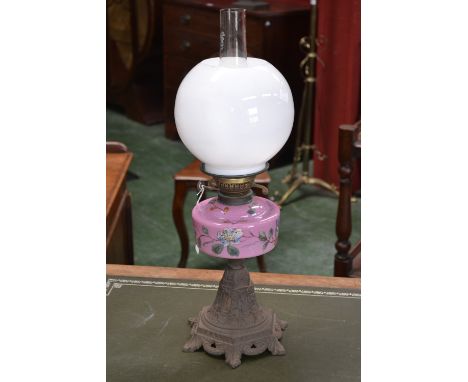 A Victorian oil lamp, with finely detailed cast iron base