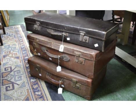 A vintage suitcase, brass fittings; two others similar