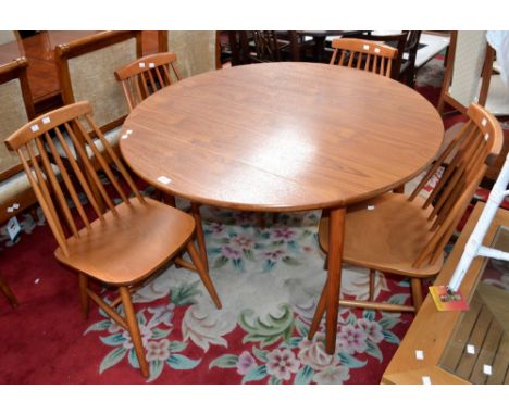 A modern dropleaf kitchen table, circular top; four Ercol style spindle back dining chairs.