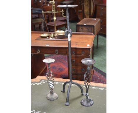 A cast iron 24" tall pricket candlestick; two brass twisted column pricket candlesticks (3)