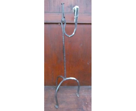 A wrought iron rush light and candle holder, 55cm high