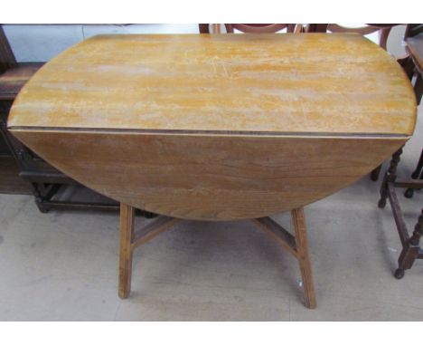 A mid-20th century light ash drop leaf dining table