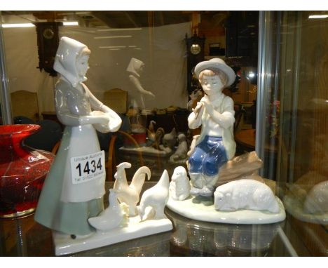 A NAO figure of a boy with sheep&nbsp;and a girl with geese.