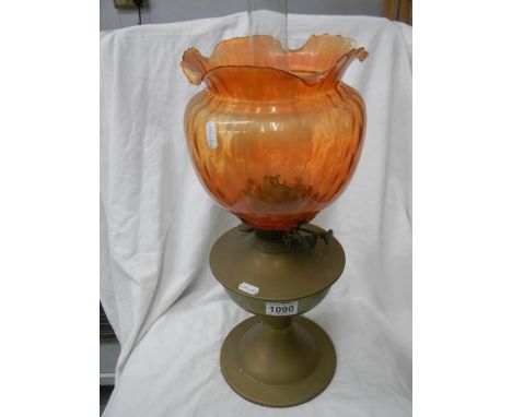 An early 20th century brass oil lamp with shade.
