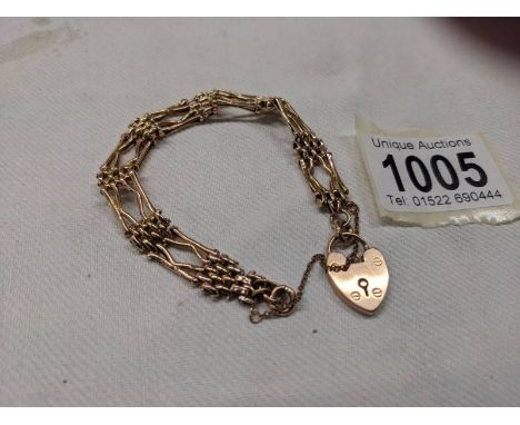 A 9ct gold gate bracelet with safety chain and padlock,&nbsp;
