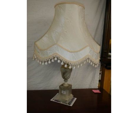 An alabaster table lamp with shade.