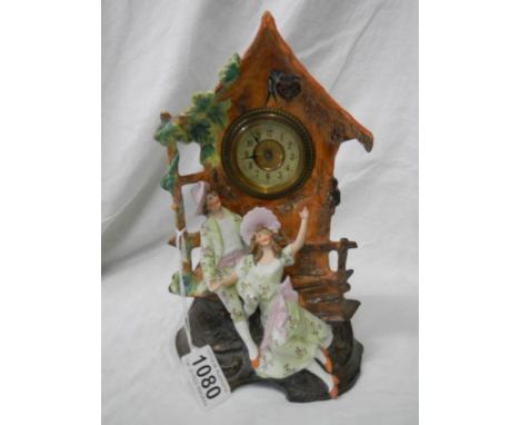 An early 20th century bisque porcelain mantel clock in working order.