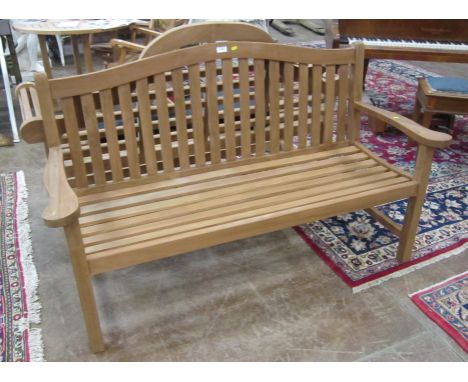 A modern teak Garden Bench with low arched back on square cut supports, 5ft 2in W