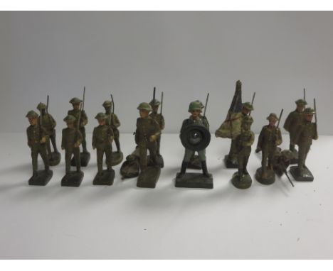 Sixteen Elastolin figures of British Soldiers and a German Soldier carrying a large lamp