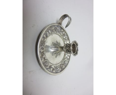 A Tiffany & Co small silver circular Chamber Candlestick with floral embossed frieze and leafage handle, No 8235M793