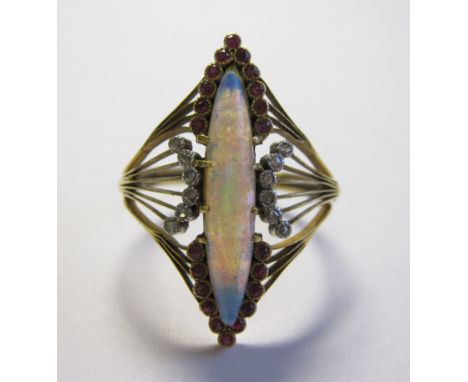 An early 20th Century French Opal, Diamond and Ruby ring the lozenge shaped wirework plaque claw-set elongated opal cabochon 