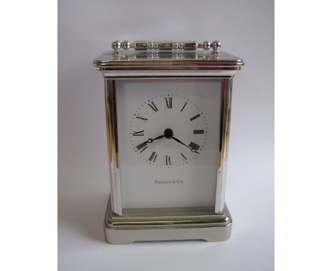 A Tiffany & Co Carriage Clock, the white dial with roman numerals in white metal case, 4 1.2in