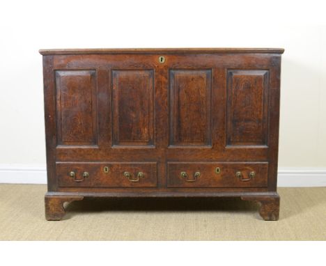 An antique oak Mule Chest with hinged lid, panelled front above two frieze drawers on bracket feet, 3ft 11in W
