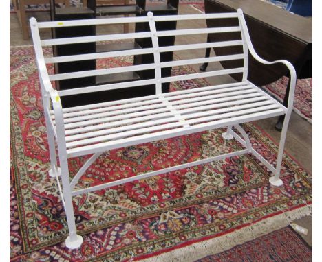 A Victorian white painted wrought iron two seater Garden Bench on octagonal flat feet, 4ft 2in W