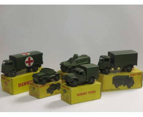 A boxed Dinky Toys No 623 Army Covered Wagon, a boxed No 641 Cargo Truck, a boxed No 673 Scout Car, a boxed No 676 Personnel 