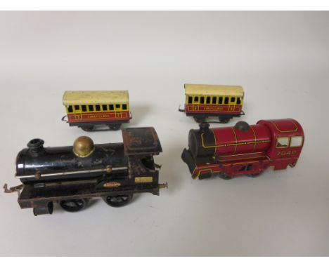 An English made tinplate Engine, tender and two carriages, anchor mark. A black Meccano locomotive 2710 clockwork stamped MLd