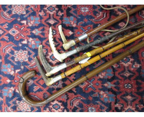 A silver collared antler handled Riding Crop, antler handled Crop stamped Swaine, two other Riding Crops and a painted metal 