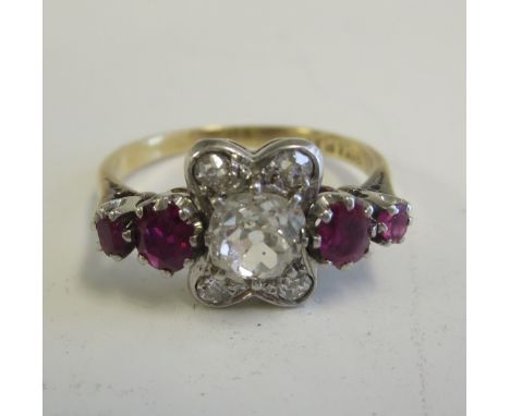 A Diamond and Ruby Ring claw-set principle diamond within four smaller stones between two pairs of rubies in 18ct gold, ring 