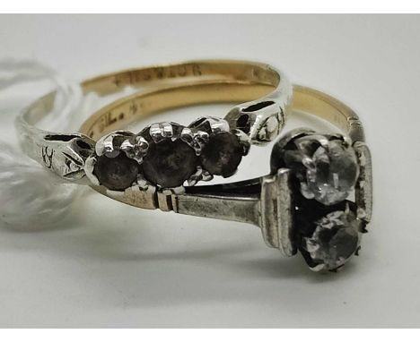 An Art Deco Style Two Stone Dress Ring, the claw set stones between stepped shoulders and slim band stamped "9ct &amp; SIL" (