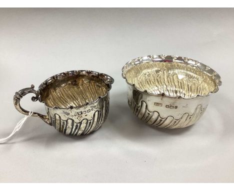 A Victorian Hallmarked Silver Milk Jug and Sugar Bowl Set, H.W, Sheffield 1896/1897, both of baluster form with partial gadro