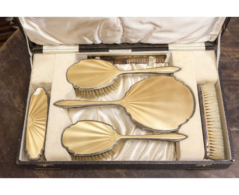 A cased silver and enamel dressing table set, Birmingham 1936, maker Adie Brothers 