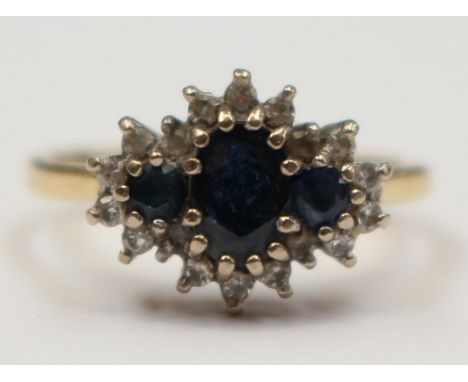 An 18ct gold cluster ring set with three sapphires and diamond surround, size K with a total gross weight approx 3.4 gms 