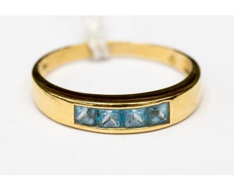 An 18ct gold ring set with four pave set square cut aquamarine stones, size S 