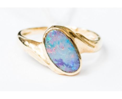 A 14k gold ring set obliquely with an oval opal, measuring 11 mm by 7 mm, size Q with a total gross weight approx 3.6 gms