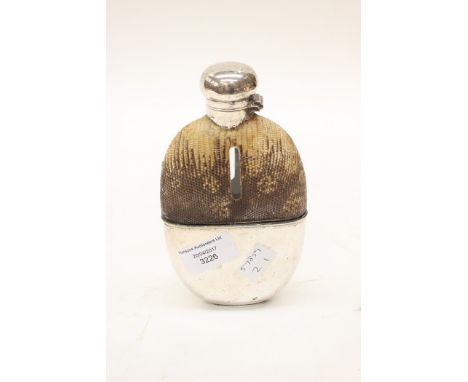 A snakeskin hip flask with glass bottle