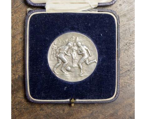 Football Medal: A silver 'Inter Platoon Football Competition' football medal embossed with a playing football scene to the fr