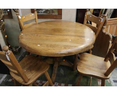A contemporary solid oak dining table and set of four chairs, comprising four ladder back chairs with solid seats, together w