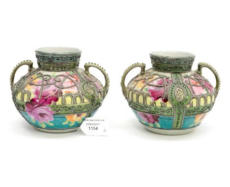 A pair of squat twin handled early 20th century vases, applied with tube lined decoration, early Noritake