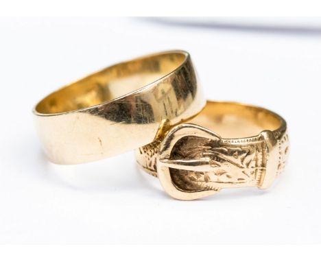 Two 9ct gold rings,one a plain wedding band, approx 7mm wide, size W the other a buckle, ring size P, with a combined total w