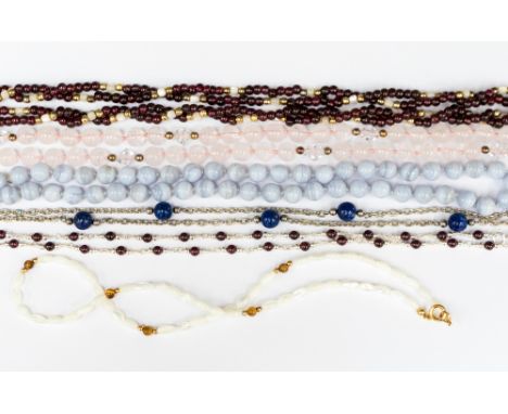 A double string of garnets and mother of pearl beads, a string of garnet and silver beads, a rope of rose quartz beads, lace 