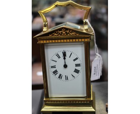 A French carriage timepiece, early 20th Century, brass portico corniche case, enamel Roman dial, height 13cmCondition Report: