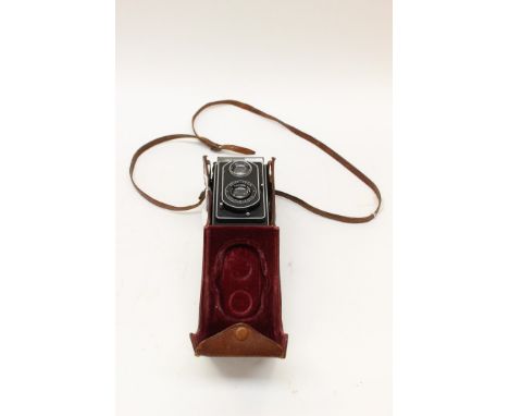 A Zeiss Ikon Ikoflex camera, with Carl Zeiss lenses, in leather case with strap 