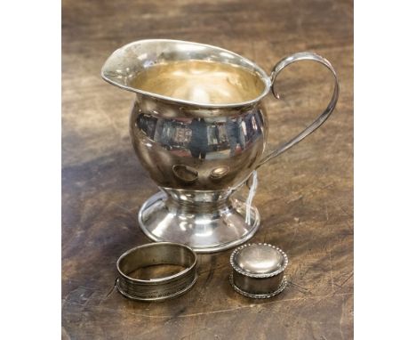 A silver pedestal jug, Birmingham 1994, with a silver trinket pot and cover, Birmingham 1927 and a silver napkin ring, Birmin